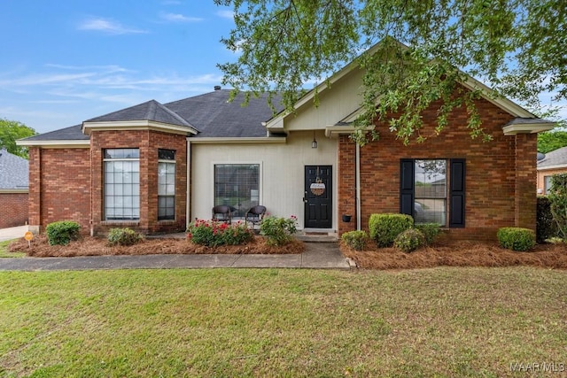 single story home with brick siding and a front yard