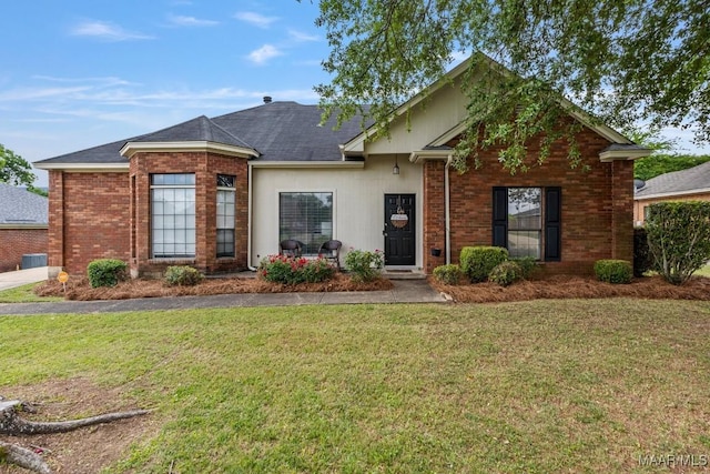 single story home with central AC unit, brick siding, and a front yard