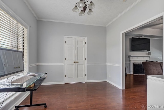 office area with crown molding, baseboards, wood finished floors, and a chandelier