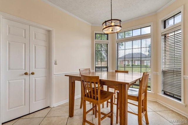 dining space featuring a textured ceiling, ornamental molding, light tile patterned flooring, and a notable chandelier