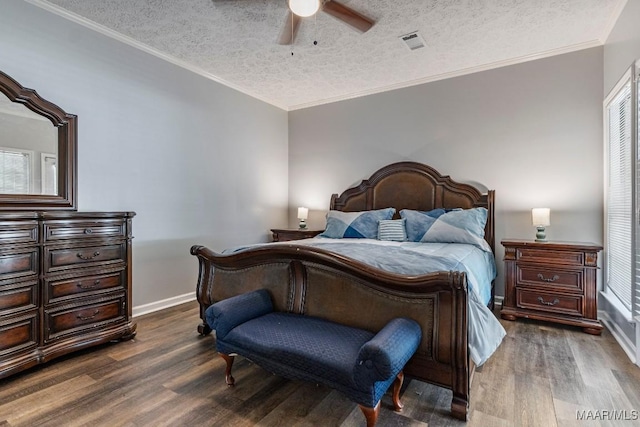 bedroom with visible vents, dark wood-style flooring, baseboards, ceiling fan, and a textured ceiling
