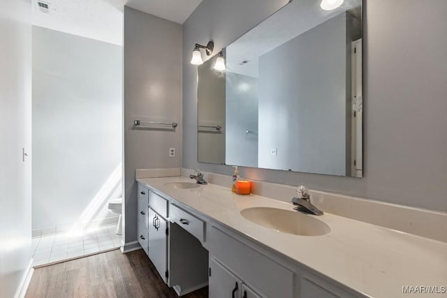 bathroom featuring a sink, tile patterned flooring, double vanity, and visible vents