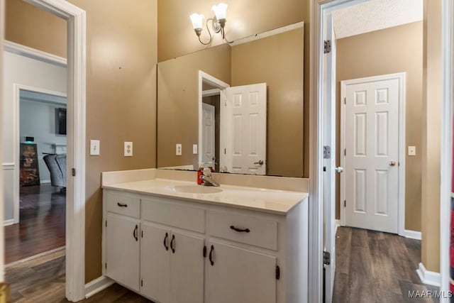 bathroom with vanity, baseboards, and wood finished floors