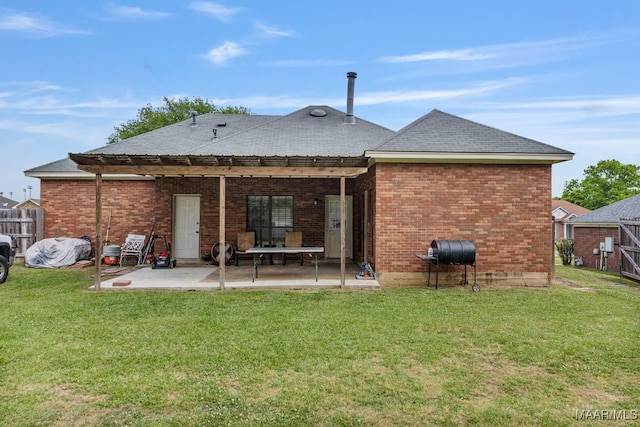 back of property with roof with shingles, a pergola, brick siding, a patio, and a yard