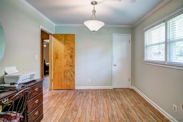 office featuring light wood-type flooring, ornamental molding, and baseboards
