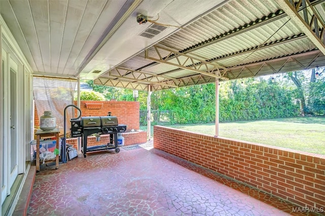 view of patio featuring fence and a grill