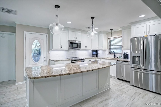 kitchen featuring crown molding, appliances with stainless steel finishes, a sink, white cabinetry, and visible vents