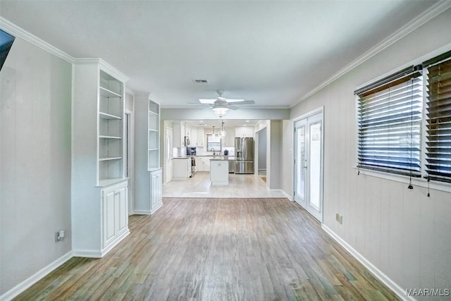 unfurnished living room featuring a ceiling fan, baseboards, visible vents, and light wood-type flooring