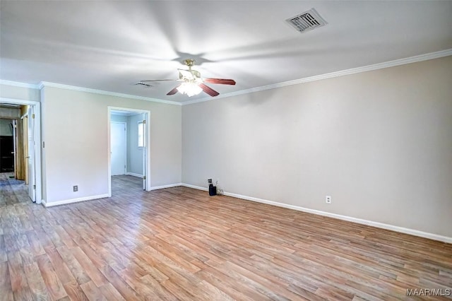 empty room featuring visible vents, crown molding, baseboards, ceiling fan, and light wood-type flooring