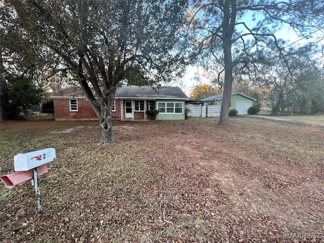 ranch-style house featuring brick siding, fence, and a garage