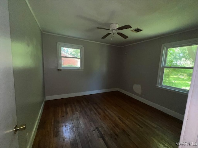 223 Mcdonald Ave, Selma, AL 36701 - spare room with dark wood-style flooring, ornamental molding, a ceiling fan, and baseboards