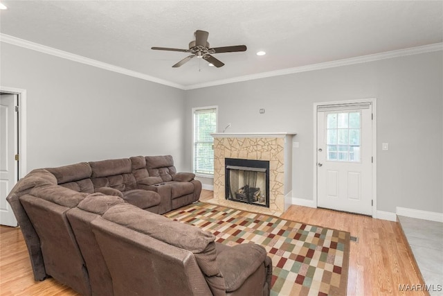 211 Carter Ln, Valley Grande, AL 36703 - living room with light wood-style floors, ornamental molding, a ceiling fan, a stone fireplace, and recessed lighting