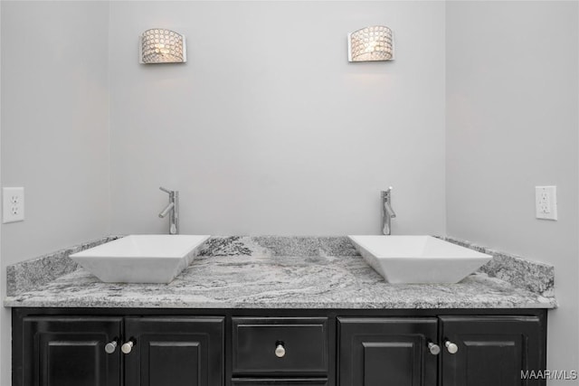 bathroom with a sink and double vanity