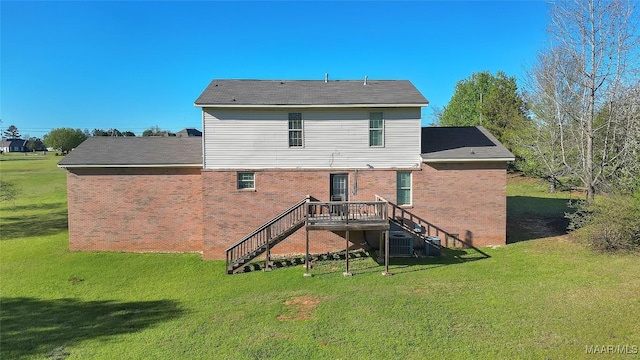 back of house featuring stairs, central AC, brick siding, a wooden deck, and a lawn