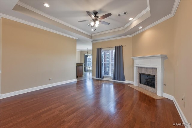 603 Coleman Way, Prattville, AL 36067 - unfurnished living room featuring a tile fireplace, ceiling fan with notable chandelier, visible vents, dark wood-type flooring, and a raised ceiling