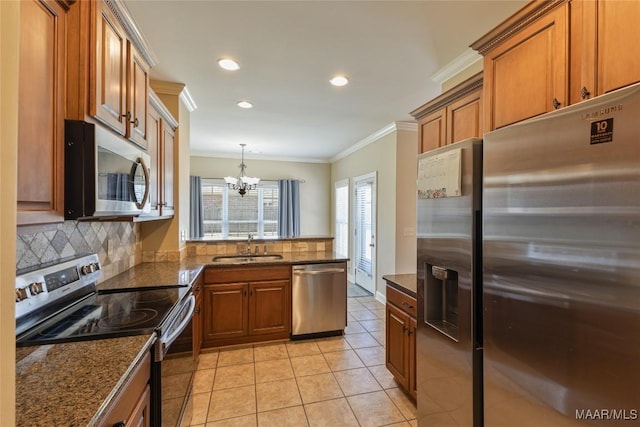603 Coleman Way, Prattville, AL 36067 - kitchen with a sink, brown cabinetry, ornamental molding, decorative backsplash, and appliances with stainless steel finishes