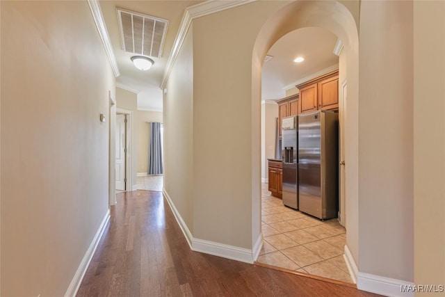603 Coleman Way, Prattville, AL 36067 - hallway featuring ornamental molding, arched walkways, light wood-style flooring, and visible vents