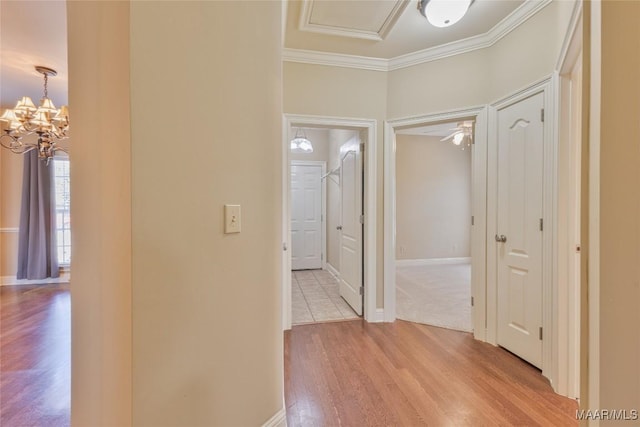 603 Coleman Way, Prattville, AL 36067 - hallway with light wood finished floors, crown molding, a chandelier, and baseboards