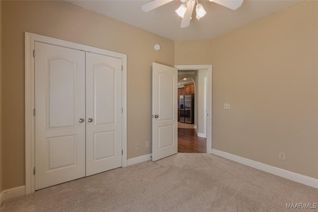 603 Coleman Way, Prattville, AL 36067 - unfurnished bedroom with a closet, carpet, baseboards, stainless steel refrigerator with ice dispenser, and arched walkways