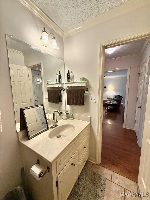 109 Lashley Dr, Selma, AL 36701 - bathroom with vanity, ornamental molding, a textured ceiling, and tile patterned floors