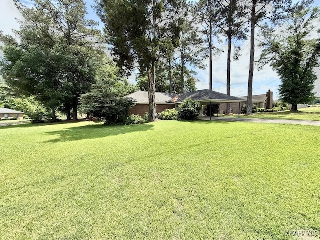 109 Lashley Dr, Selma, AL 36701 - view of yard featuring an attached carport and driveway