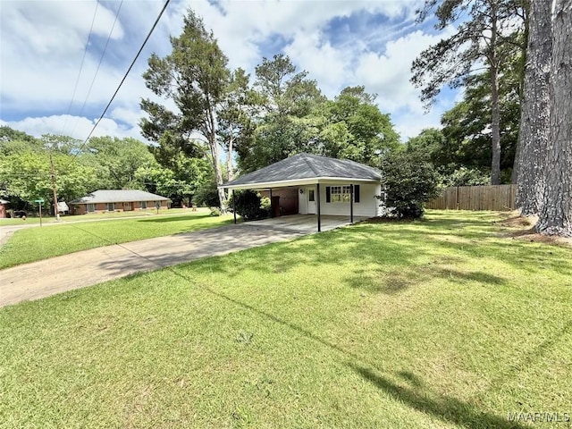 109 Lashley Dr, Selma, AL 36701 - view of yard featuring concrete driveway, fence, and an attached carport