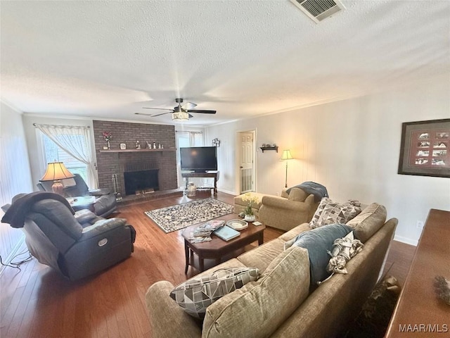 109 Lashley Dr, Selma, AL 36701 - living room with a textured ceiling, visible vents, wood-type flooring, and ceiling fan