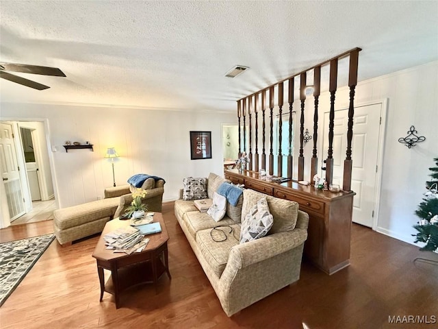 109 Lashley Dr, Selma, AL 36701 - living room featuring wood finished floors, a textured ceiling, visible vents, a ceiling fan, and baseboards