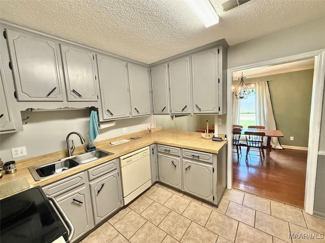 109 Lashley Dr, Selma, AL 36701 - kitchen featuring white dishwasher, black electric range oven, a notable chandelier, a textured ceiling, and a sink