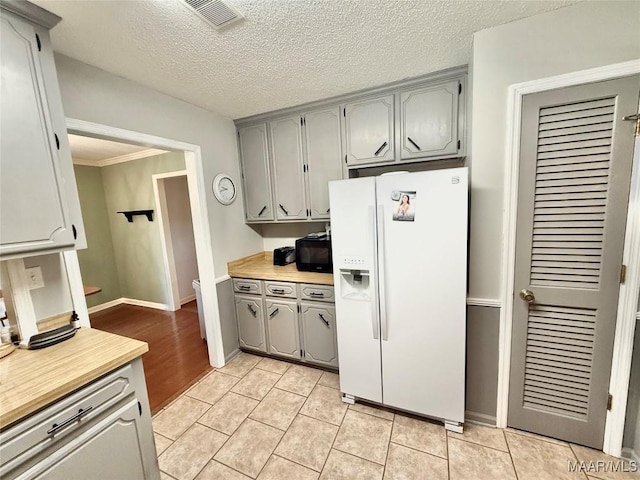 109 Lashley Dr, Selma, AL 36701 - kitchen with light countertops, white fridge with ice dispenser, gray cabinets, and visible vents