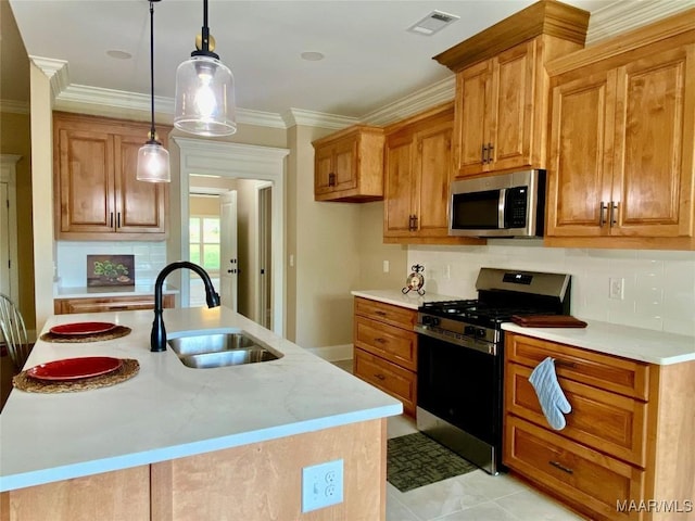 kitchen featuring brown cabinetry, visible vents, a sink, stainless steel appliances, and tasteful backsplash