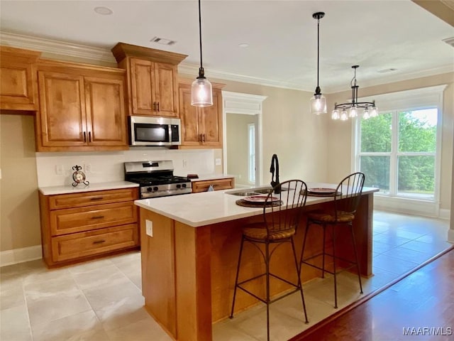 kitchen featuring brown cabinets, a sink, stainless steel appliances, visible vents, and light countertops
