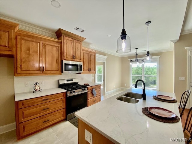 kitchen featuring visible vents, a sink, backsplash, brown cabinets, and stainless steel appliances