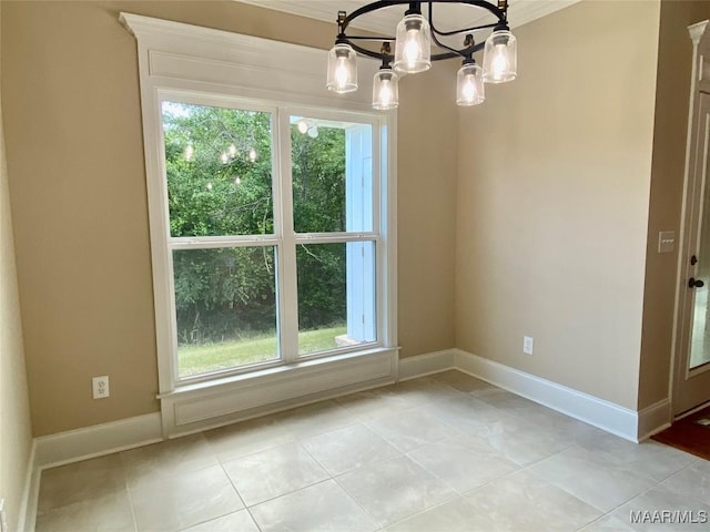 unfurnished dining area with baseboards, an inviting chandelier, and plenty of natural light