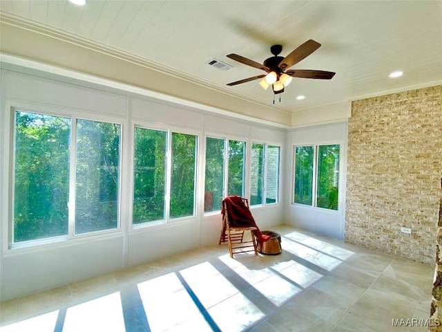 sunroom with recessed lighting, ornamental molding, visible vents, and plenty of natural light