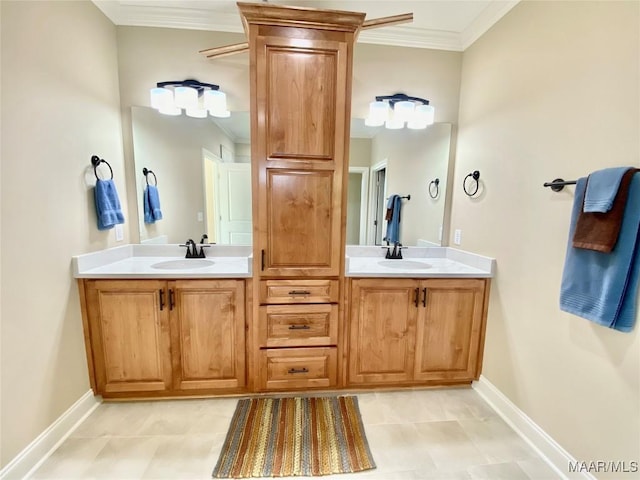 full bathroom with double vanity, crown molding, baseboards, and a sink