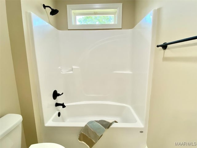 full bath featuring toilet and bathing tub / shower combination