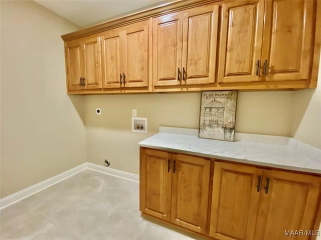 clothes washing area with baseboards, hookup for a washing machine, cabinet space, and electric dryer hookup