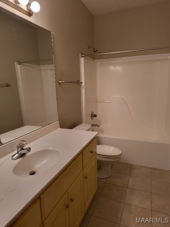 bathroom with tile patterned floors, toilet, vanity, and washtub / shower combination