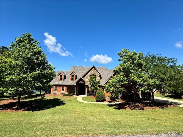 155 Edge Wood Ct, Mathews, AL 36052 - cape cod home featuring a front lawn and stone siding