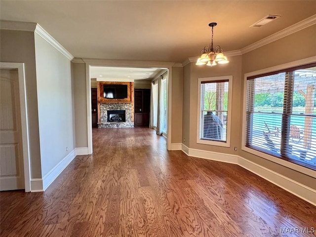 155 Edge Wood Ct, Mathews, AL 36052 - unfurnished dining area with crown molding, dark wood-type flooring, baseboards, a stone fireplace, and a chandelier