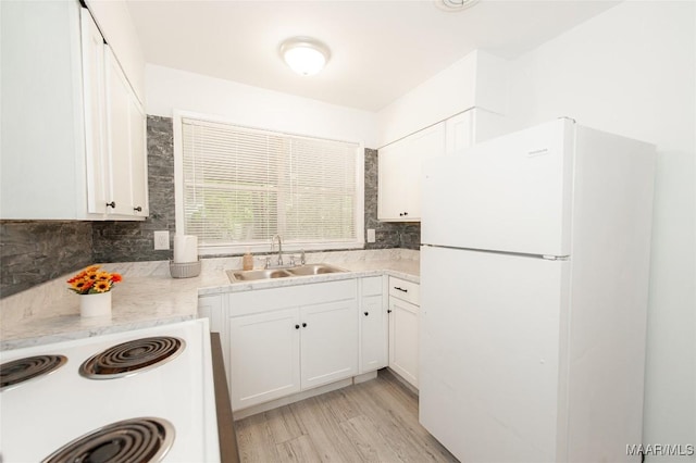 1701 Sylvan Dr, Montgomery, AL 36106 - kitchen featuring white appliances, a sink, backsplash, and white cabinets