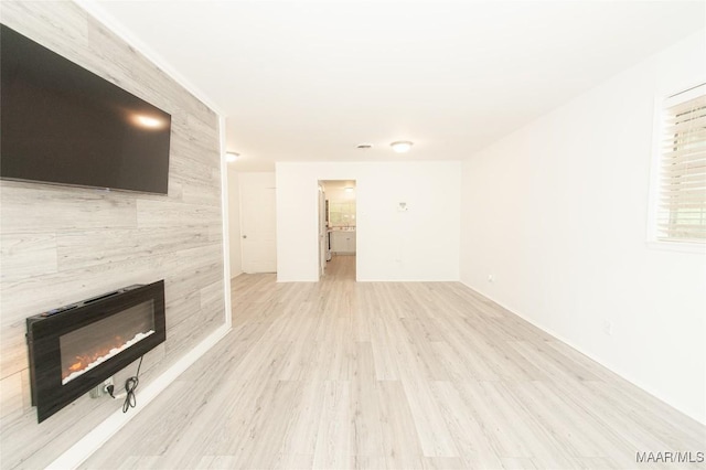 1701 Sylvan Dr, Montgomery, AL 36106 - unfurnished living room with light wood-type flooring and a tiled fireplace
