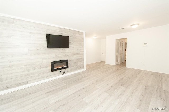 1701 Sylvan Dr, Montgomery, AL 36106 - unfurnished living room with a tiled fireplace and wood finished floors