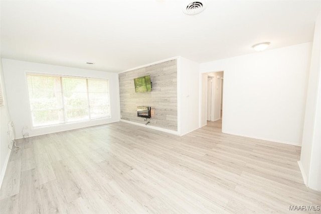 1701 Sylvan Dr, Montgomery, AL 36106 - unfurnished living room featuring light wood-style floors and baseboards