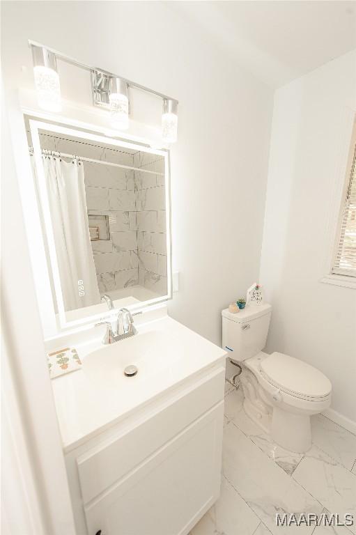 1701 Sylvan Dr, Montgomery, AL 36106 - bathroom with toilet, marble look tiles, vanity, curtained shower, and baseboards