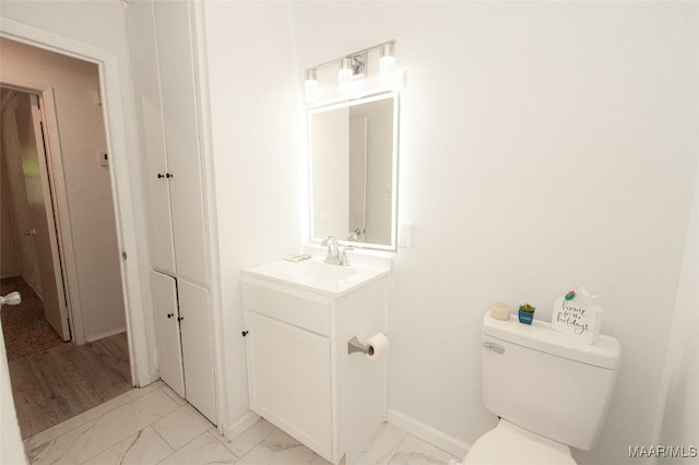 1701 Sylvan Dr, Montgomery, AL 36106 - half bathroom with marble finish flooring, toilet, vanity, and baseboards