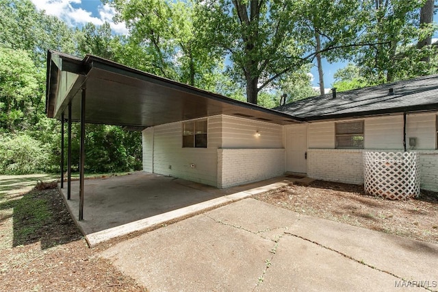 1701 Sylvan Dr, Montgomery, AL 36106 - view of side of home featuring driveway, brick siding, and a carport
