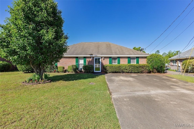 ranch-style home with a front lawn and brick siding