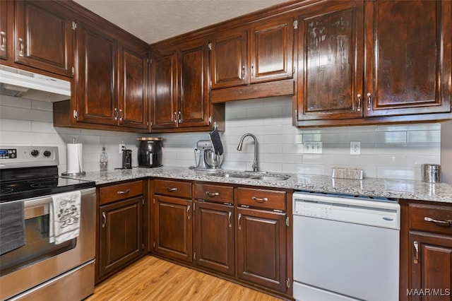 kitchen featuring a sink, stainless steel electric range, backsplash, under cabinet range hood, and white dishwasher